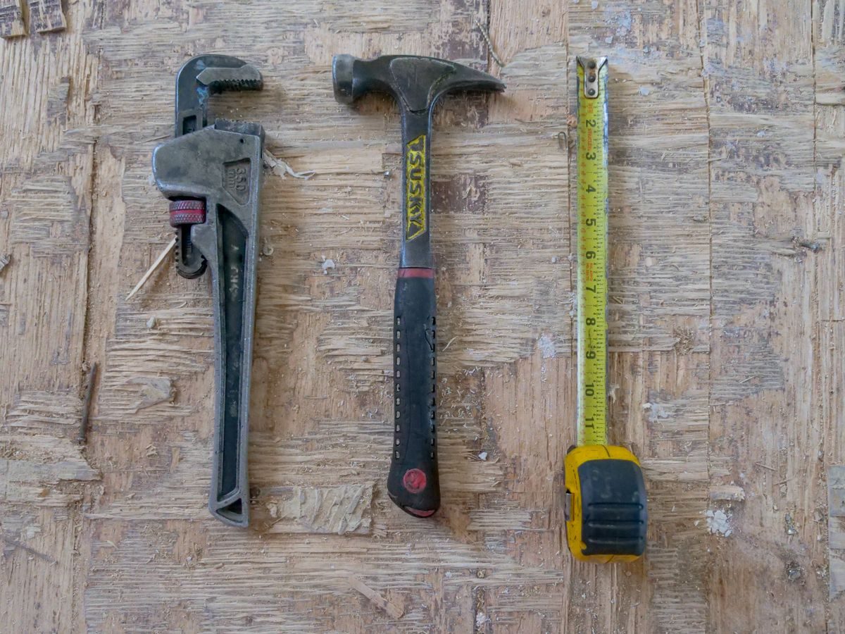 Professional drain cleaning tools laid out on wood