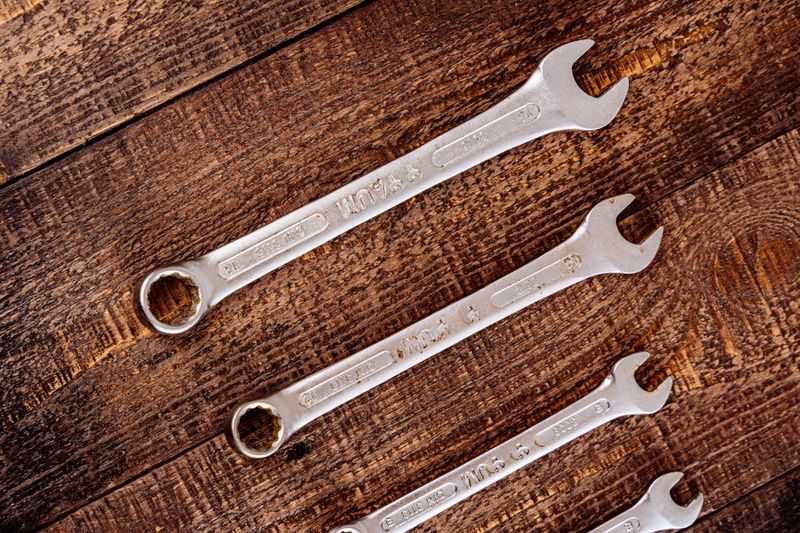 Professional plumbing wrenches on a workbench